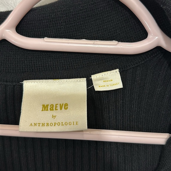 Full length black top with collar and flared sleeves containing gold buttons. - Picture 3 of 3